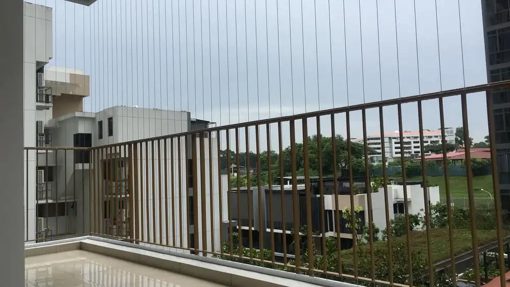Invisible grille cables installed on Condo balcony railing, Singapore skyline view