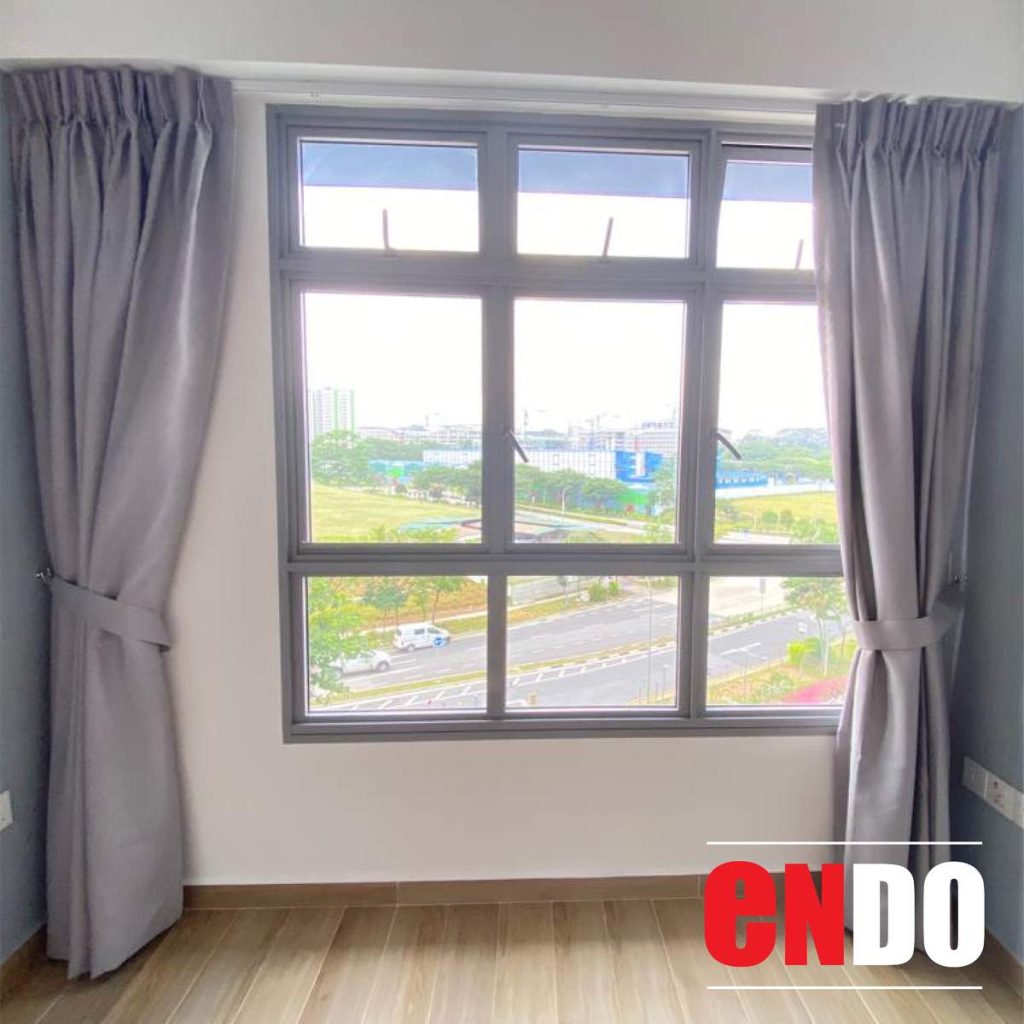 Grey day and night curtains filtering natural light through window during daytime