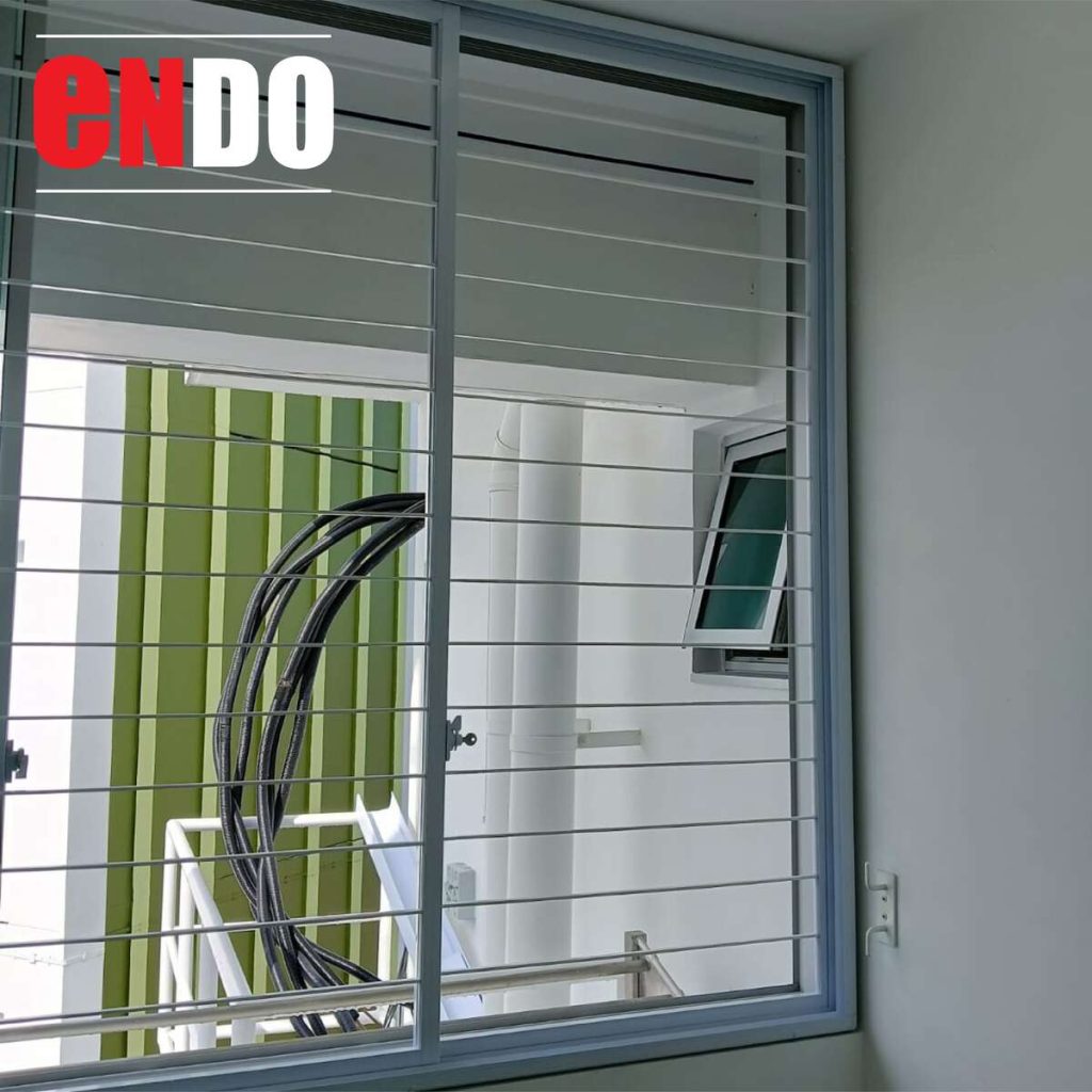 Sleek Grille on sliding window with HDB yellow facade view
