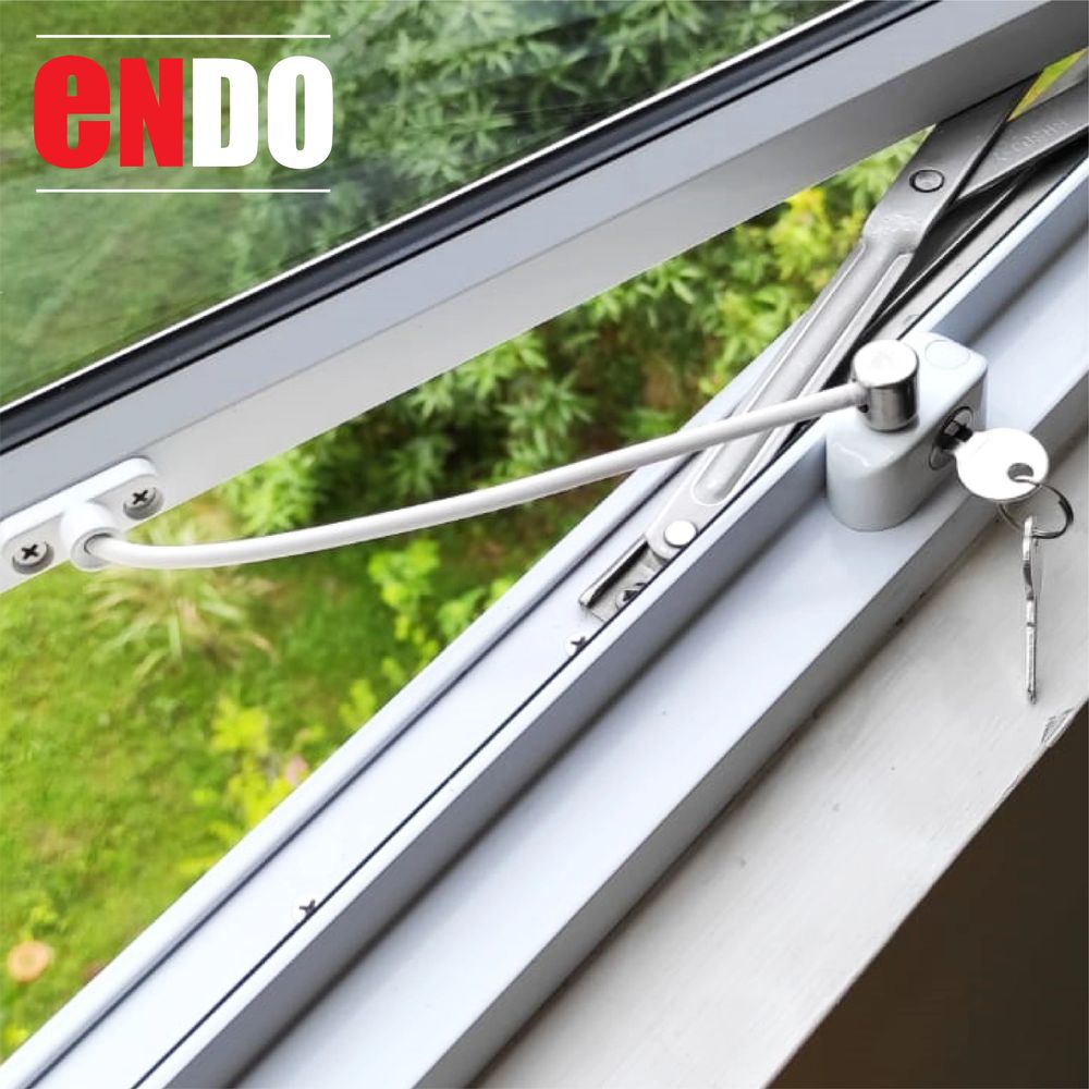 Close-up of Ezi Lock V2 window restrictor mechanism and cable on window frame