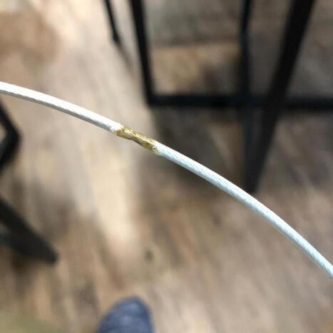 Nylon invisible grille cable after burning test showing discolouration